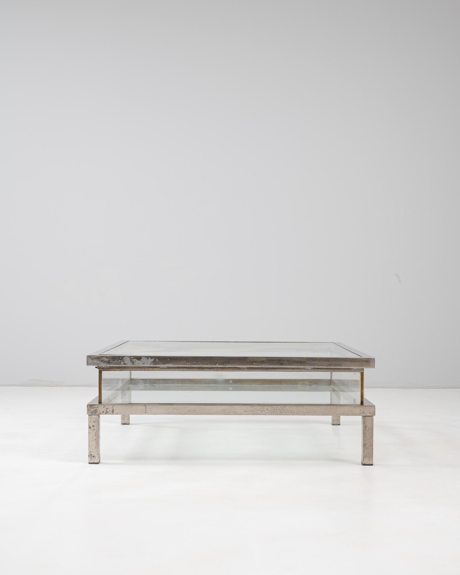 This 20th Century Italian chrome and glass coffee table by Belgo Chrom features a minimalist architectural frame with a refined industrial aesthetic. The rectangular structure is composed of a polished chrome base with patinated surface variations,