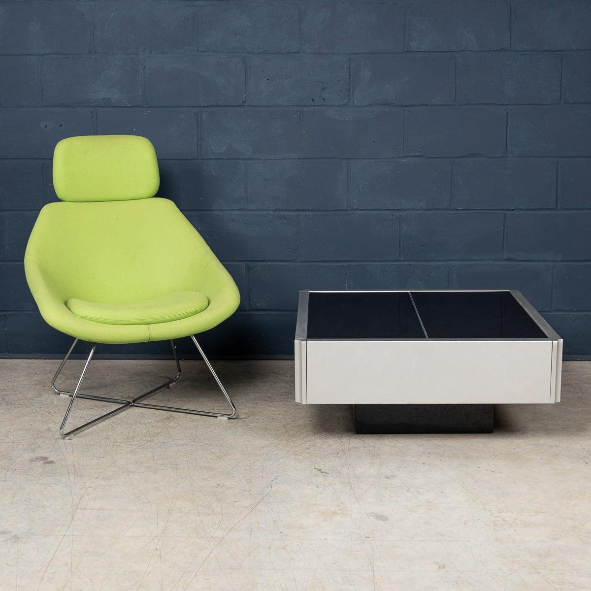 A striking Willy Rizzo-style coffee table showing the sleek sophistication of Space Age and contemporary design. Made in Italy in the 1970s, it features a black plexiglass-covered top that opens in two parts to reveal an integrated bar. Its bold