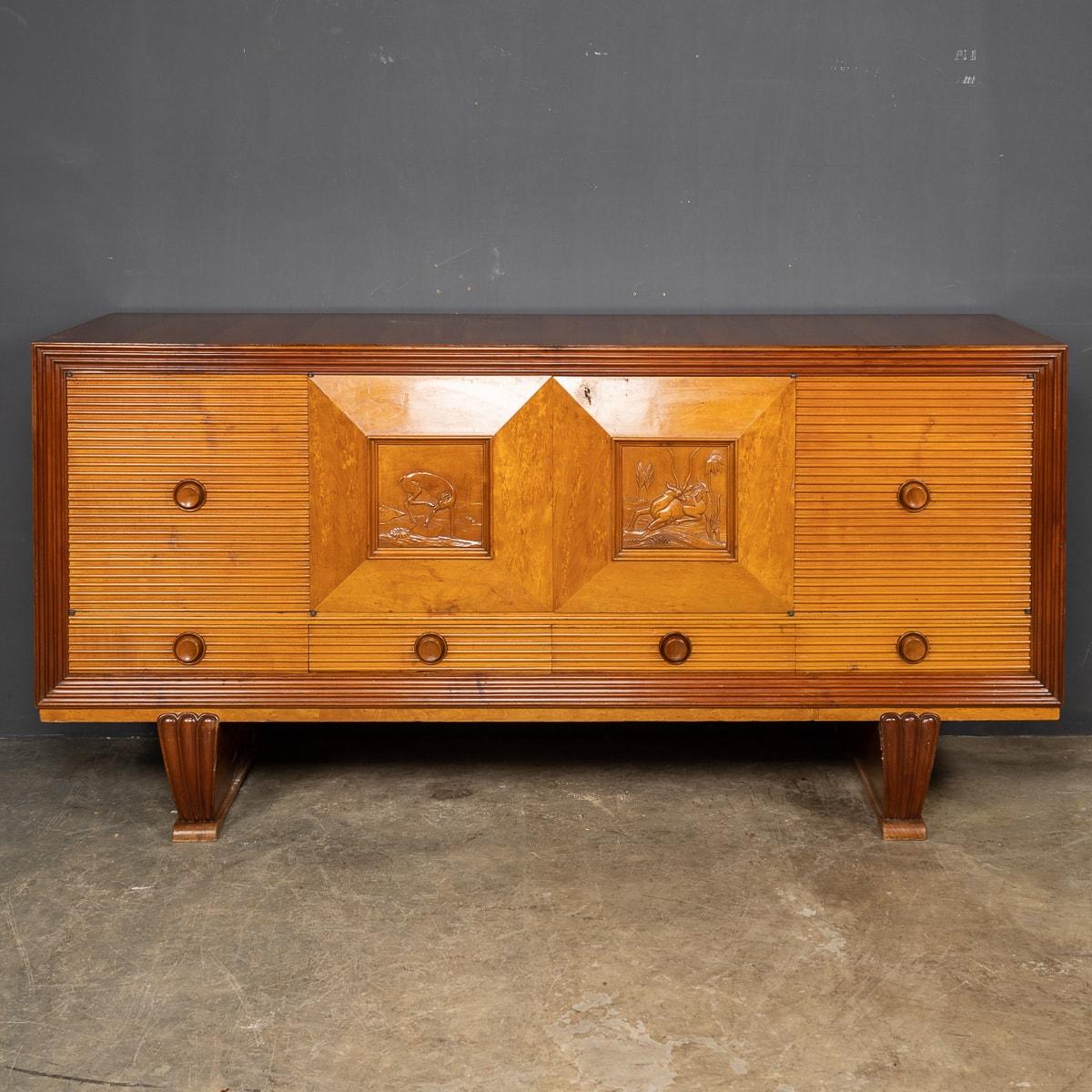 A stunning Mid-20th Century wooden credenza by attributed to Paolo Buffa. This piece has a detailed carving of wild deer in the centre panel, perfectly proportioned doors, drawers and solid wood concave handles.

CONDITION
In Great Condition - No