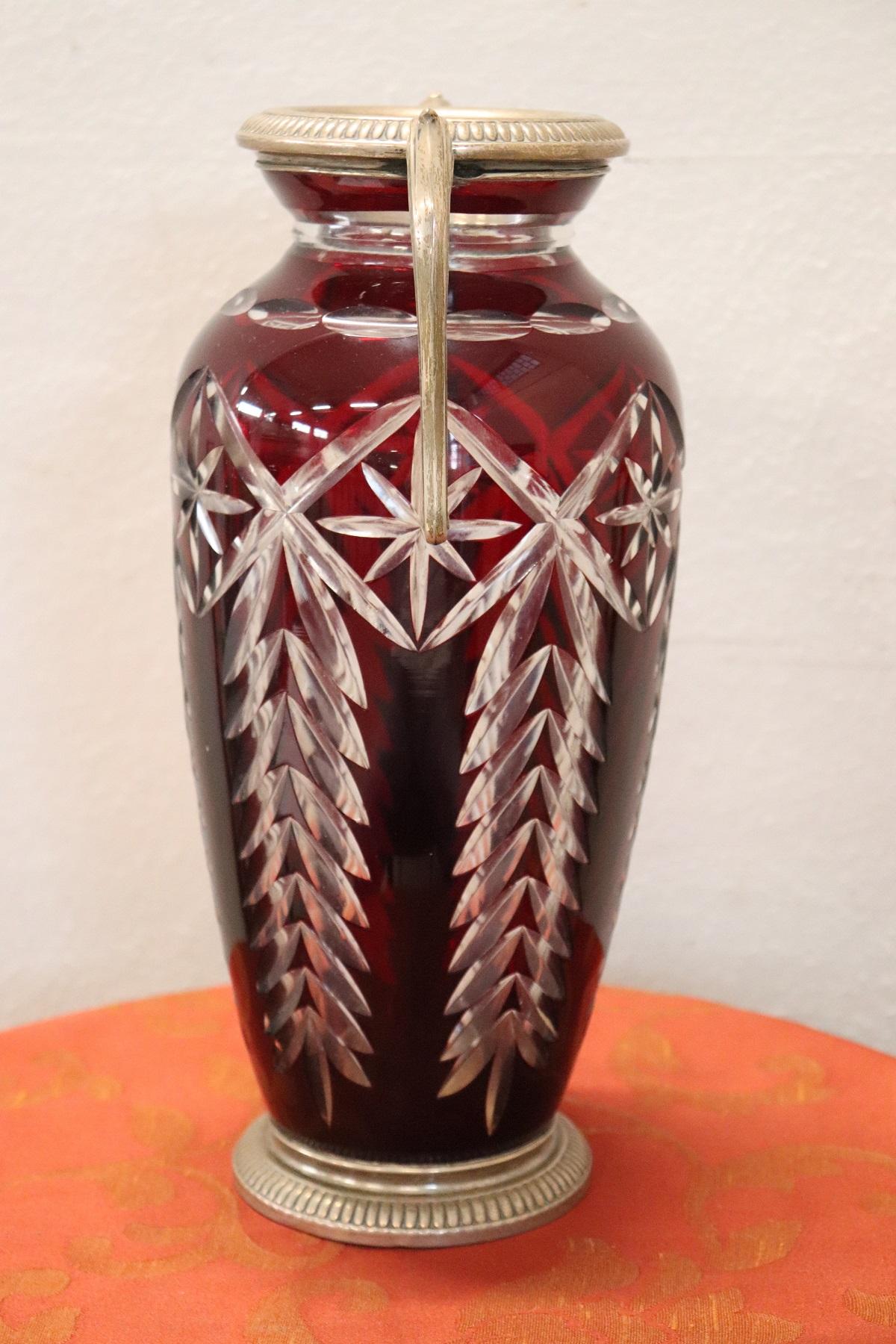 Beautiful large crystal vase. The red crystal has a refined workmanship and typical light. Precious elements in 800 silver.