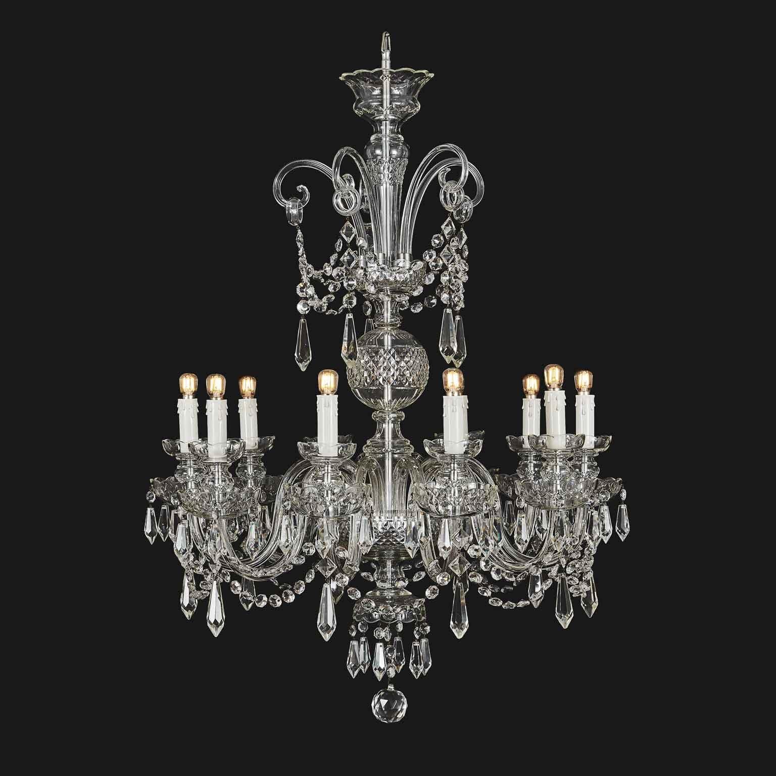 Italian ten-light chandelier realized with Bohemian crystal around 1950s. This is a classical crystal Georgian style chandelier decorated with crystal chains and drops. In good condition and working for European standard, this Italian chandelier is