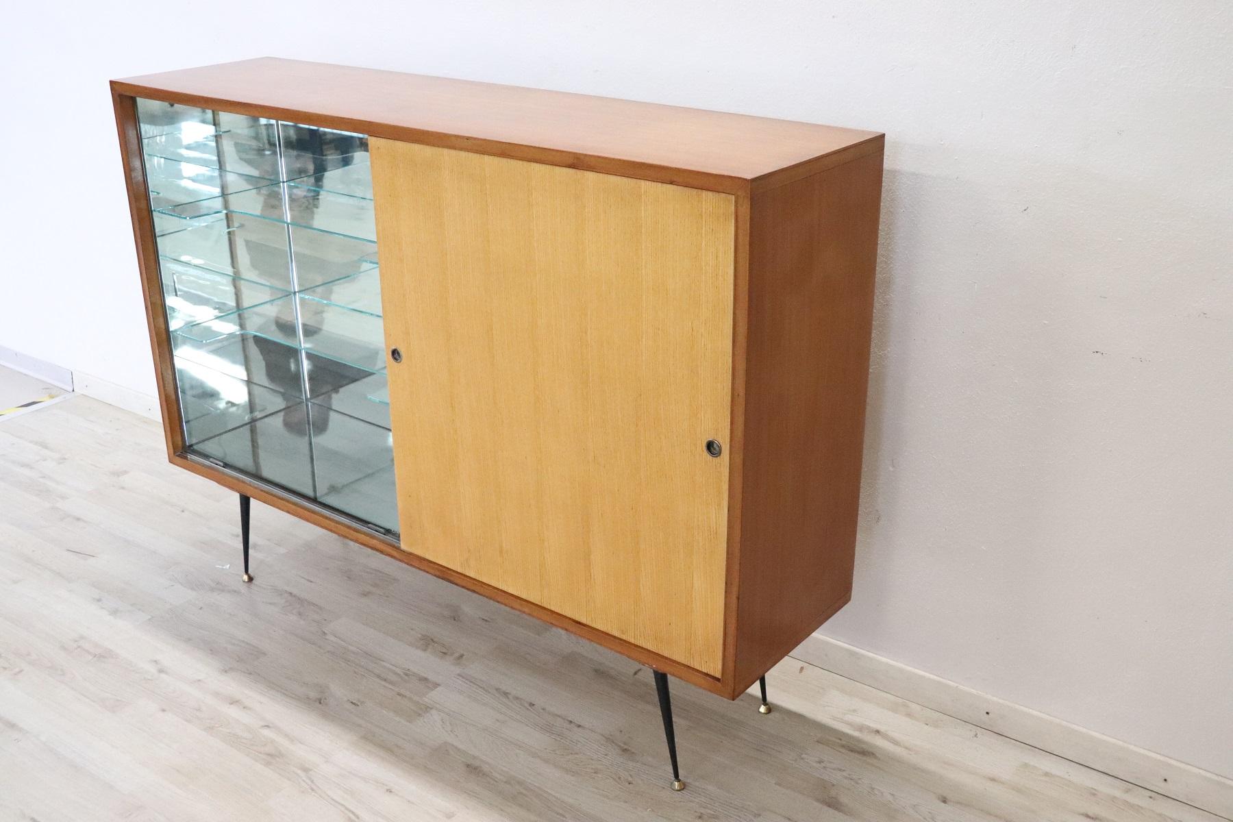 Beautiful and rare Italian design bar cabinet in teak, 1960s. One part has a bar cabinet with space for bottles with mirror. Perfect for a modern and young environment. Used good conditions.