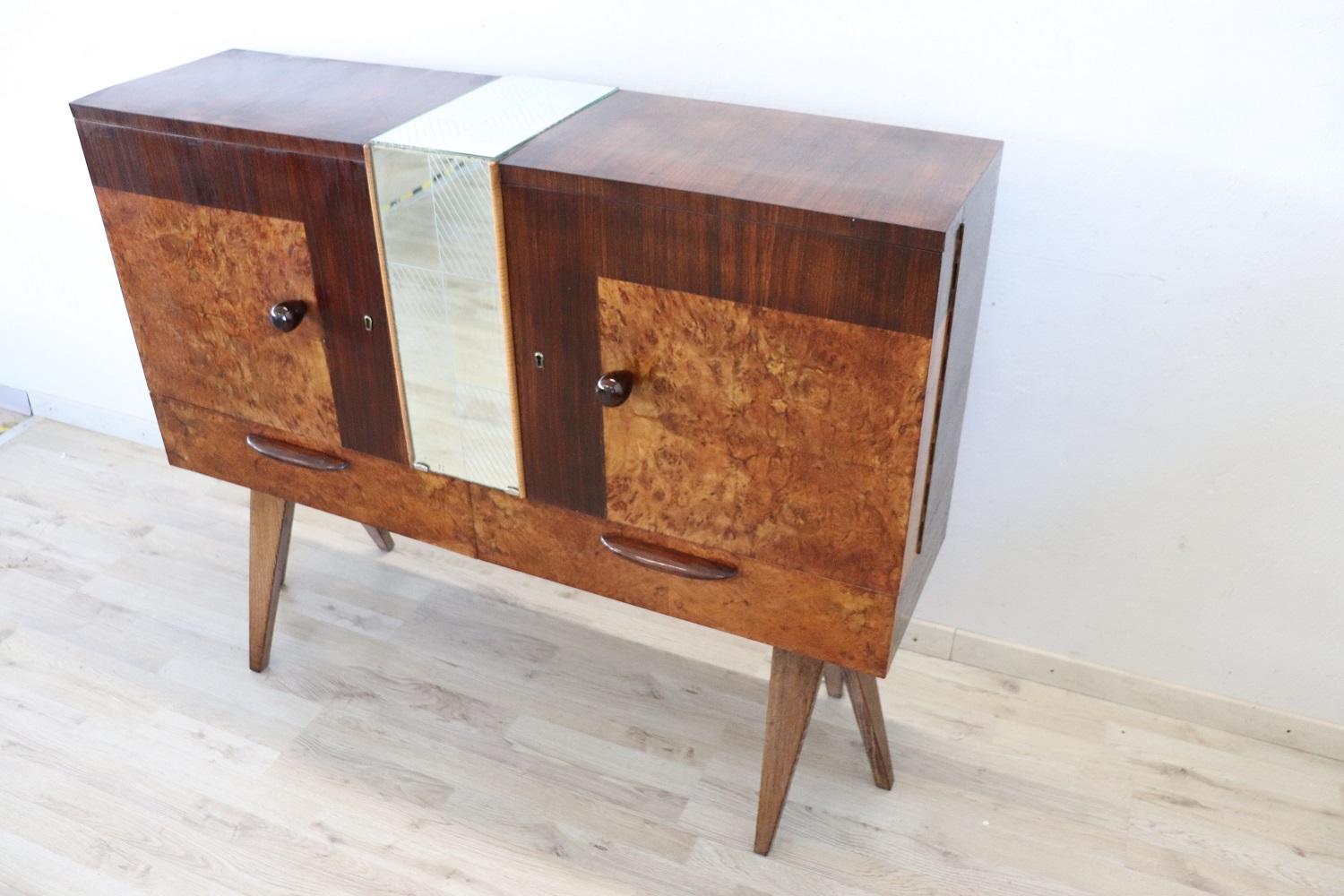 Beautiful and rare Italian design bar cabinet 1960s. Made of fine birch burl and rosewood. Equipped in the lower part with two comfortable drawers. Internally equipped with a mirror on the bottom to better see your bottles. Perfect for a modern