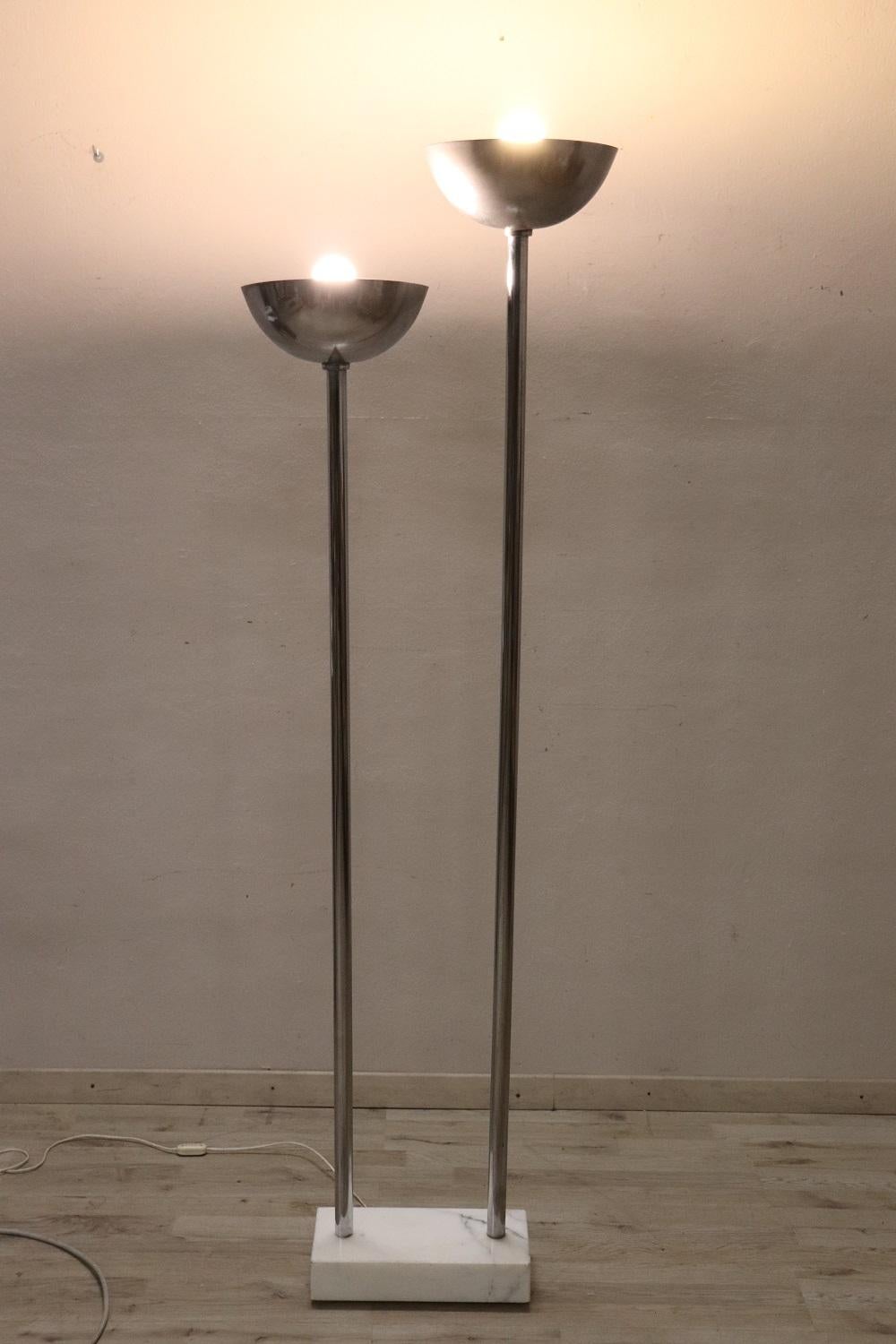 Beautiful floor lamp in chromed metal 1980s Italian design. Working. Some signs of wear. There are no trademarks or signatures. Very elegant, for vintage environments. Characterized by two lights and a beautiful and refined base in white Carrara