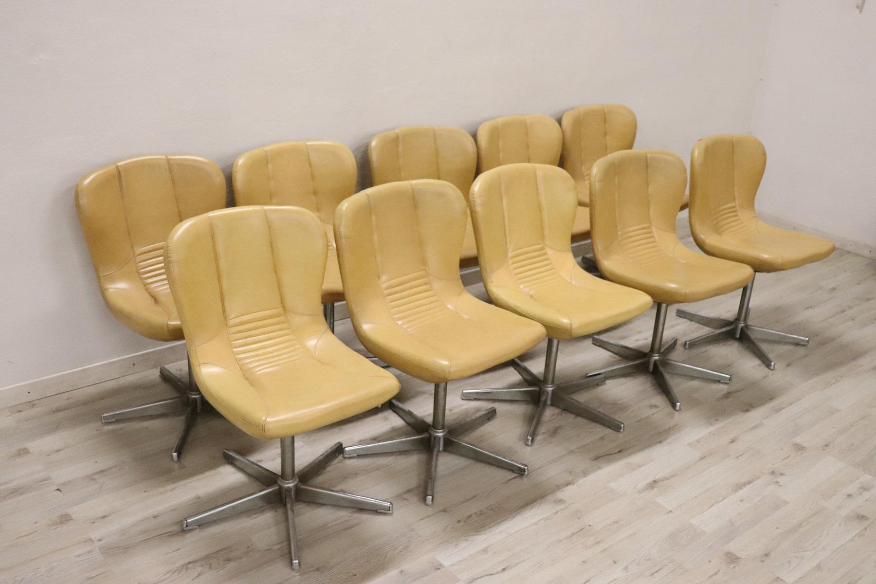 Beautiful and rare series of ten Italian design armchairs or chairs from the 1960s. Made with a chromed metal pedestal, the armchairs are swivel. Covered in used leather but in very good condition small signs of wear, only one armchair has a burn on