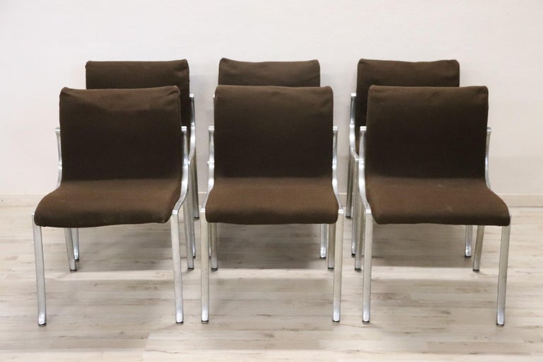 Beautiful and rare series of three Italian design chairs from the 1970s in the style Osvaldo Borsani. The chairs have a chromed metal frame and a brown fabric cover. The fabric in general is in good condition the internal padding shows signs of
