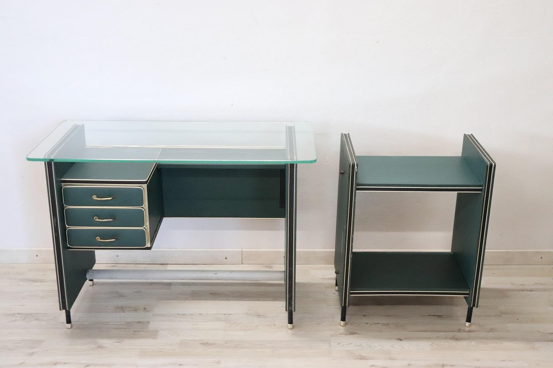 Refined and rare office furniture set Italian design 1950s by Umberto Mascagni in green faux leather. Top with original glass. 
This set consists of:
1 desk inch W 39,37 D 19,68 H 27,55 cm W 100 D 50 H 70
1 printer holder inch W 20,07 D 14,17 H