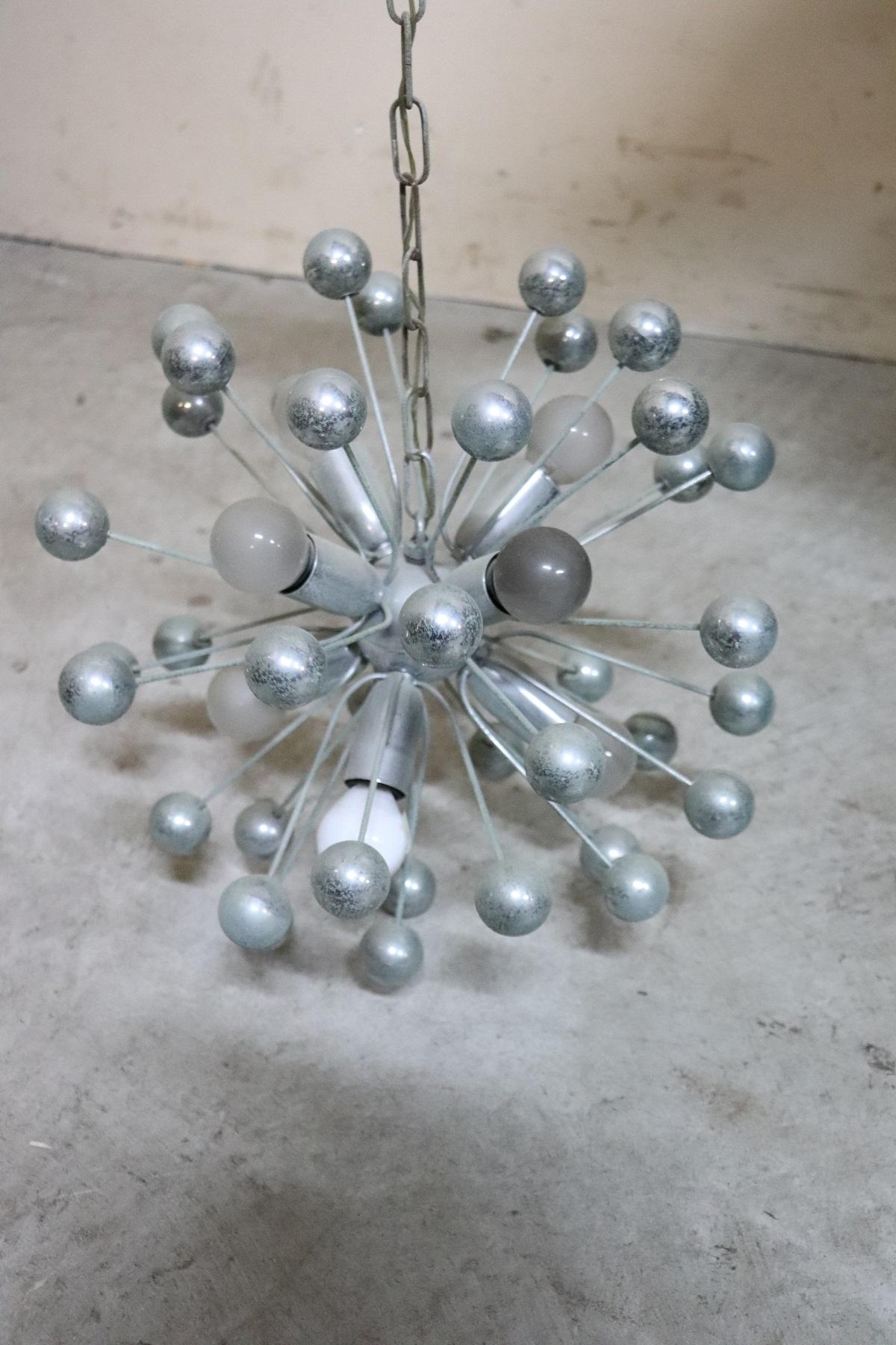 Beautiful and refined Italian chandelier from the circa 1980s made of chromed metal. Very bright eight interior lights. Used conditions. The height can be adjusted as desired the rings of the chain can be removed or added.