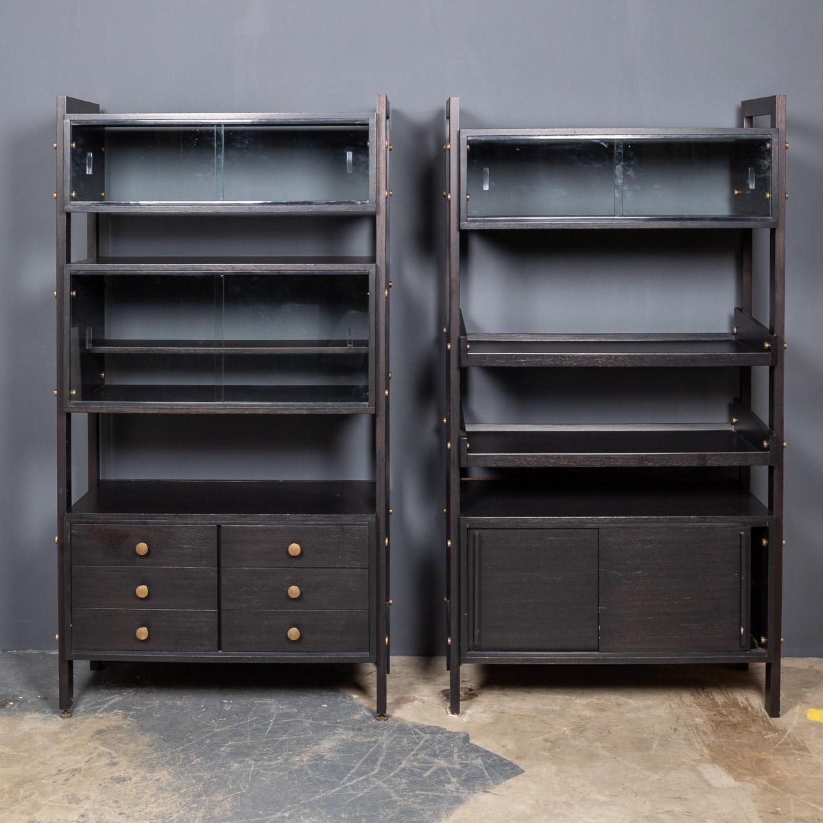 Striking 20th Century Italian ebonised pair of étagères with open back and storage compartment at the bases with brass handles.

Measures: Width: 93cm
Height: 176cm
Depth: 43cm.