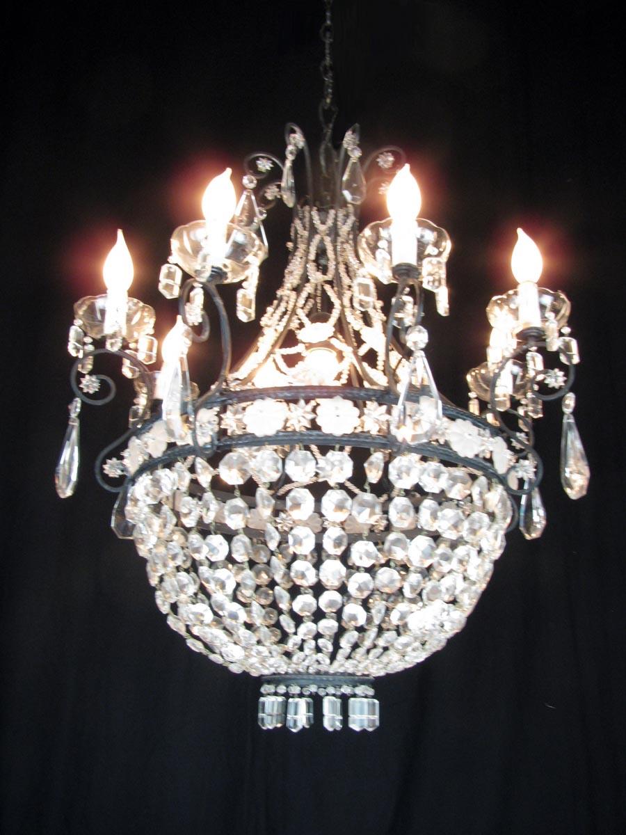 Italian crystal chandelier with Empire style drop-shaped iron structure, eight curved arms ending with eight crystal bobeches. The upper part of the iron structure is originally decorated with a beaded crystal network, whereas the lower part is