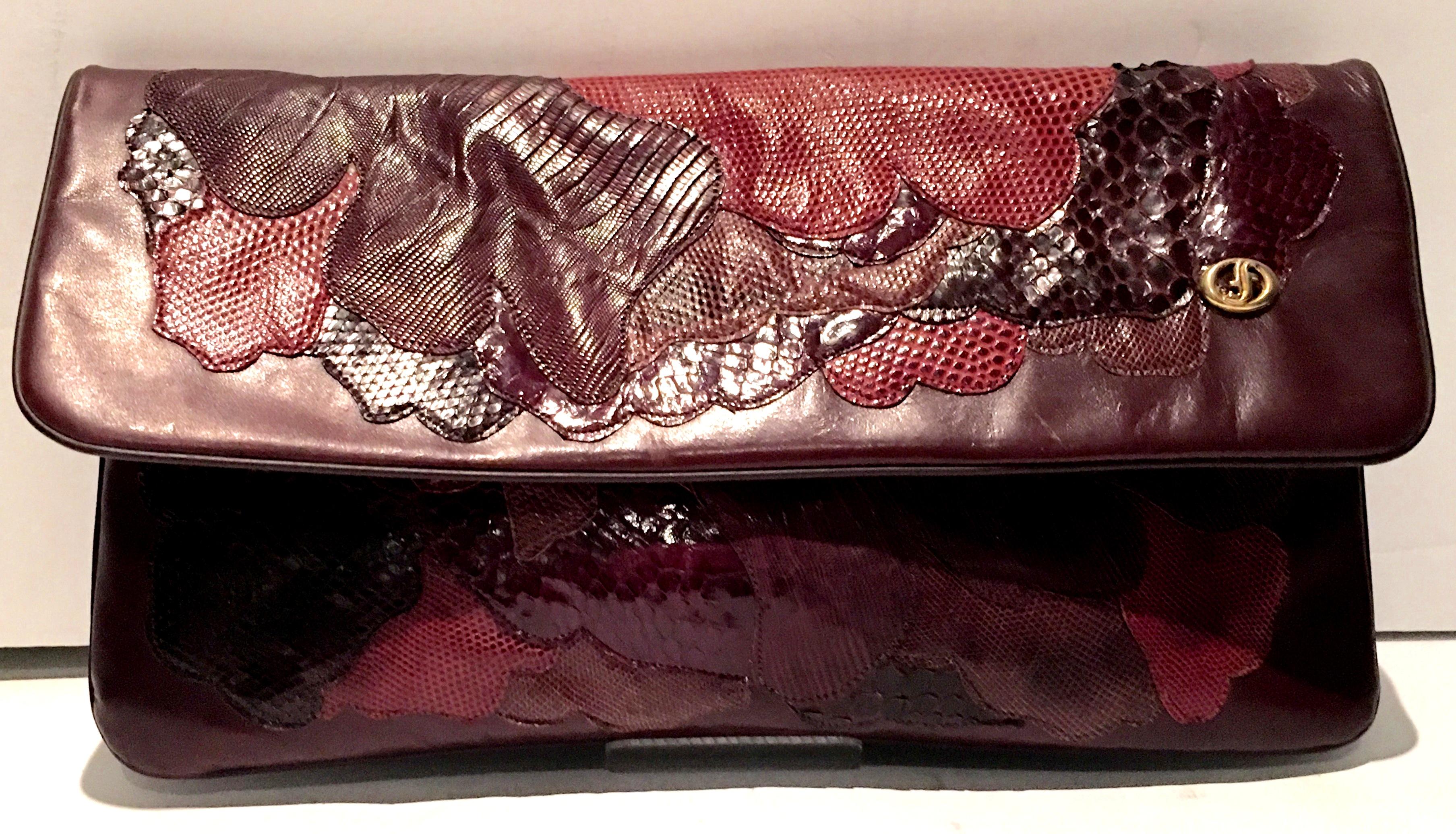 Vintage Italian Leather & Python Patchwork Clutch Hand Bag, By Carlos Fiori. This pristine oxblood leather hand bag features several exotic species in tones of deep and vibrant reds with brown hand stitched in a abstract patchwork pattern, both