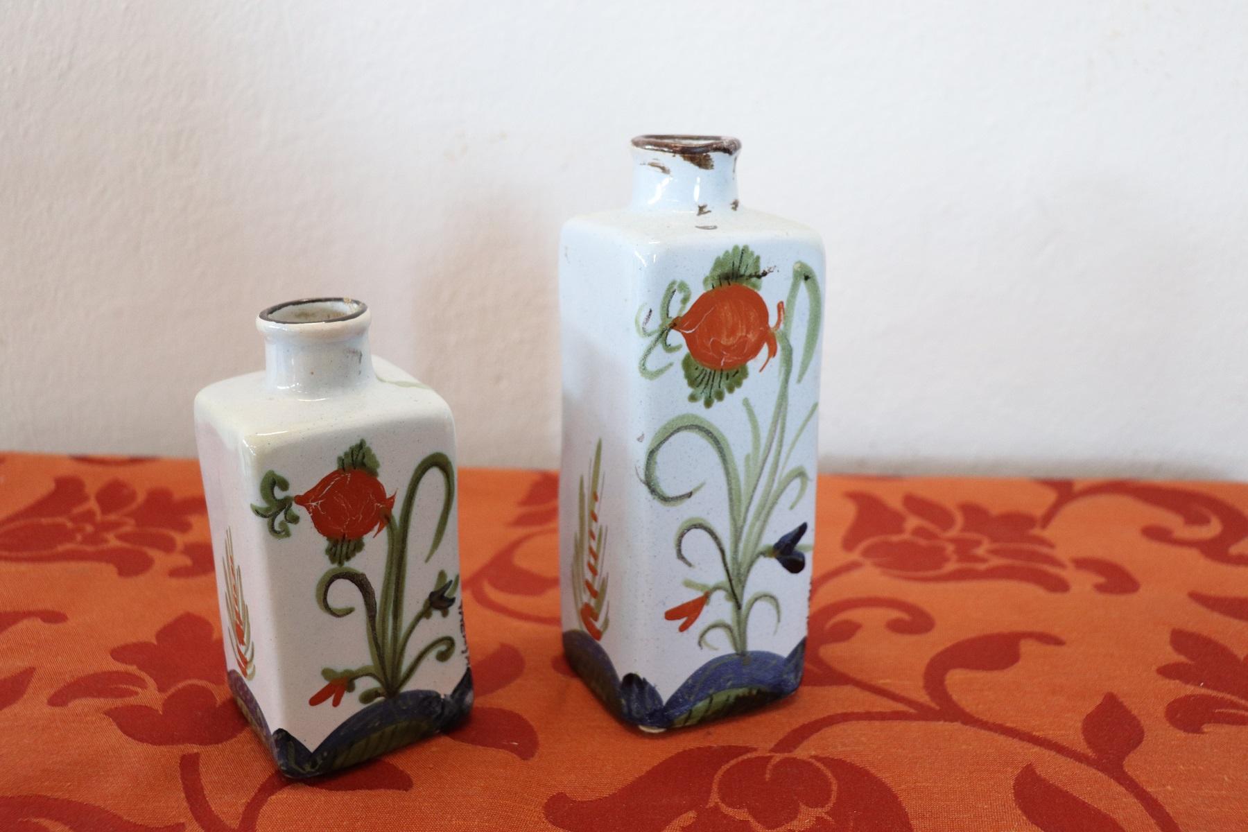 Beautiful bottles in polychrome ceramic with hand painting decorations. Classical floral decoration. Signed Italian manufacture Faenza.
Measure: Height of the bottles cm 18 and cm 13.
  