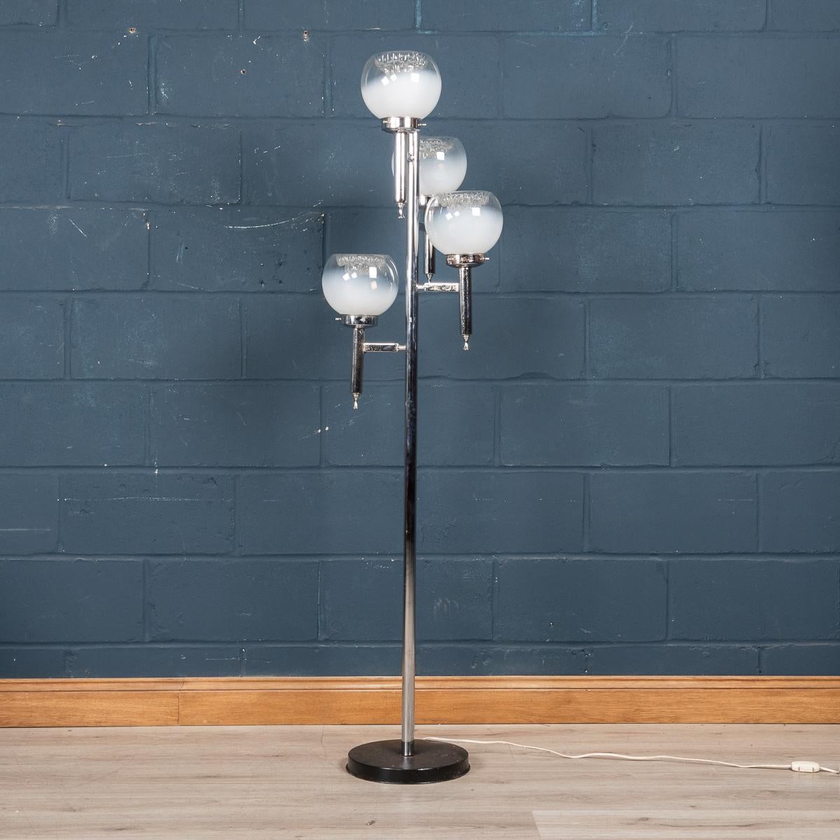 A delightful floor lamp manufactured in the manner of Gaetano Sciolari by Mazzega, made in the famous island of Murano, Venice, in Italy around the 1970's. A circular base with a pedal switch supports a chrome metal frame with four beautiful