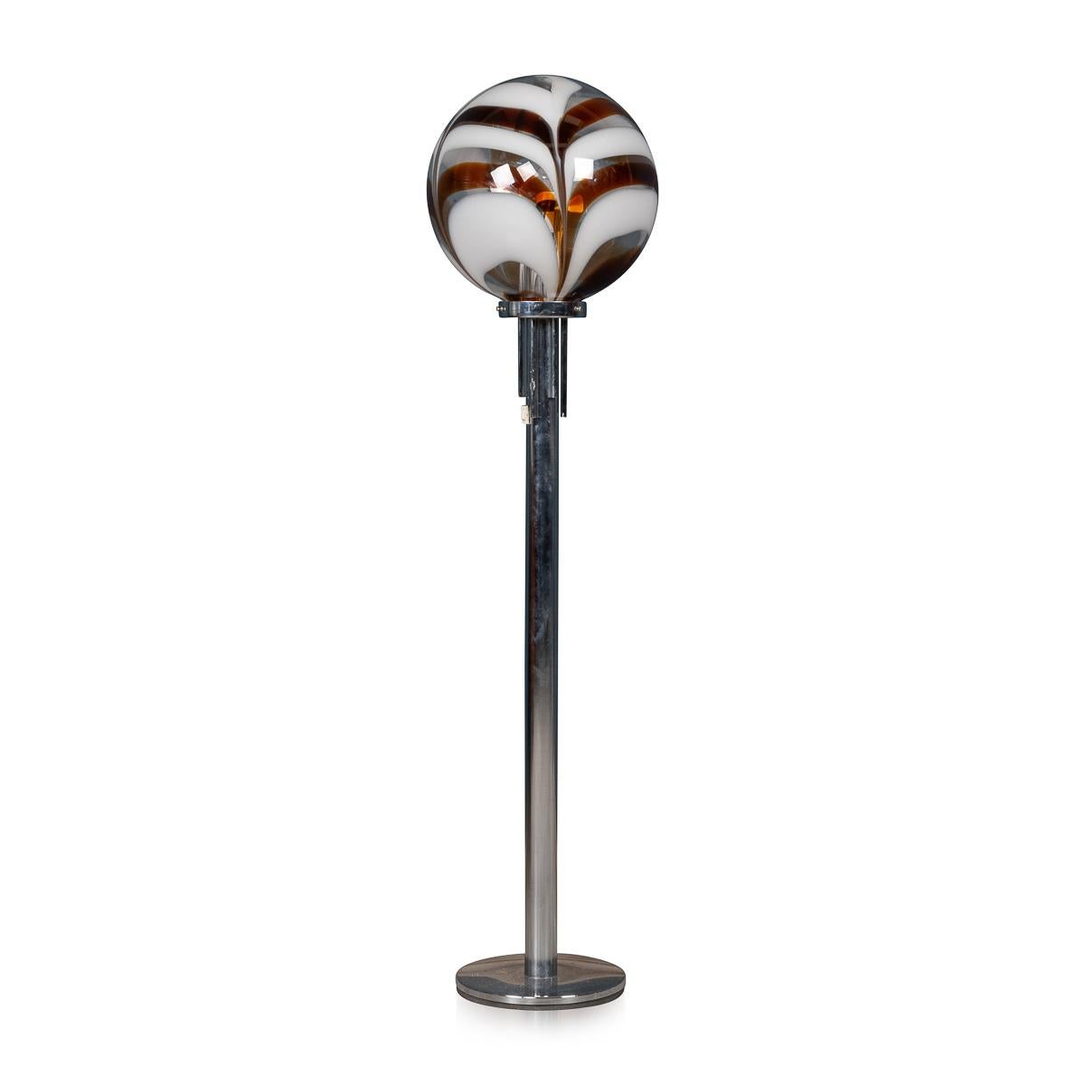 An elegant chrome and glass floor lamp made in Italy around the middle of the 20th century. The chrome stand supports a glass ball which has been entirely realised by hand by the expert glass makers located on the island of Murano in Venice, Italy.