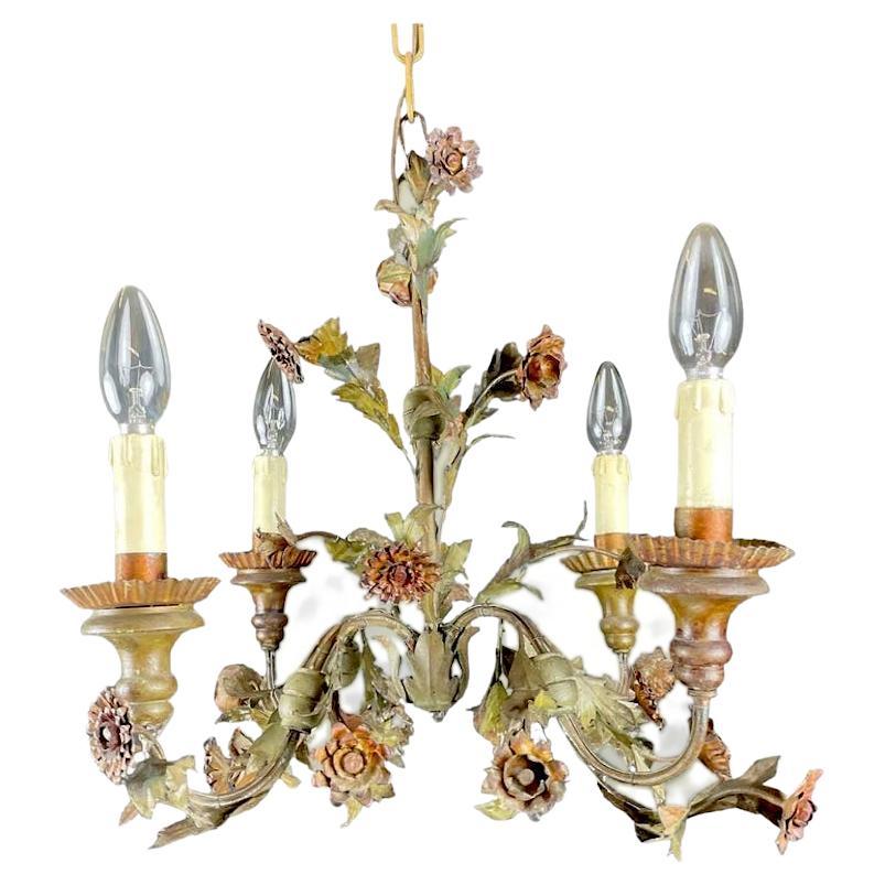 An Italian Piedmontese painted tôle four-light chandelier from the 20th century, born in Italy during the first half of 20th century, this charming painted tôle chandelier captures our attention with its green foliage, hand painted red flowers, this