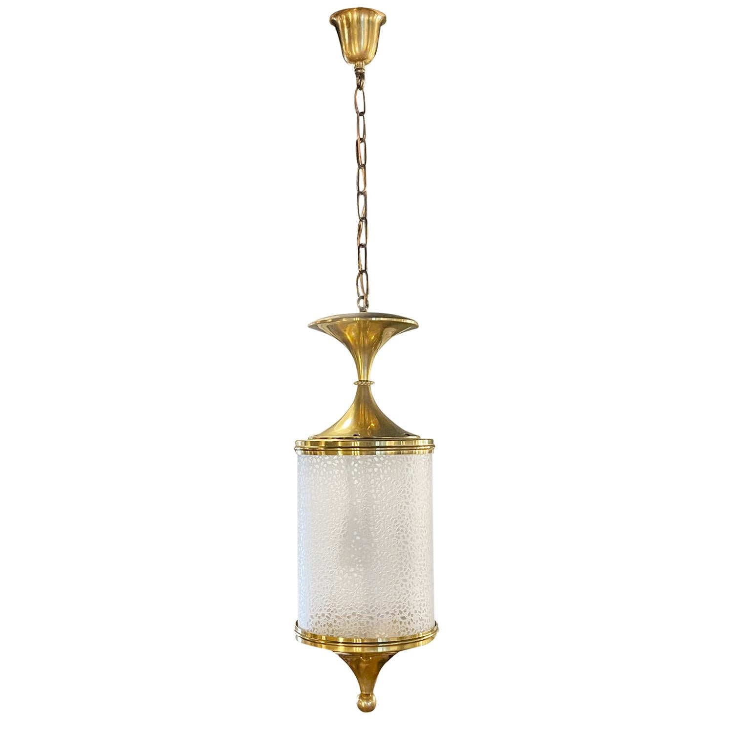 A vintage Art Deco Italian chandelier made of handcrafted brass and hand blown smoked crystal glass, designed by Pietro Chiesa and produced by FontanaArte, in good condition. The hanging ceiling pendant is featuring a three light socket. The wires