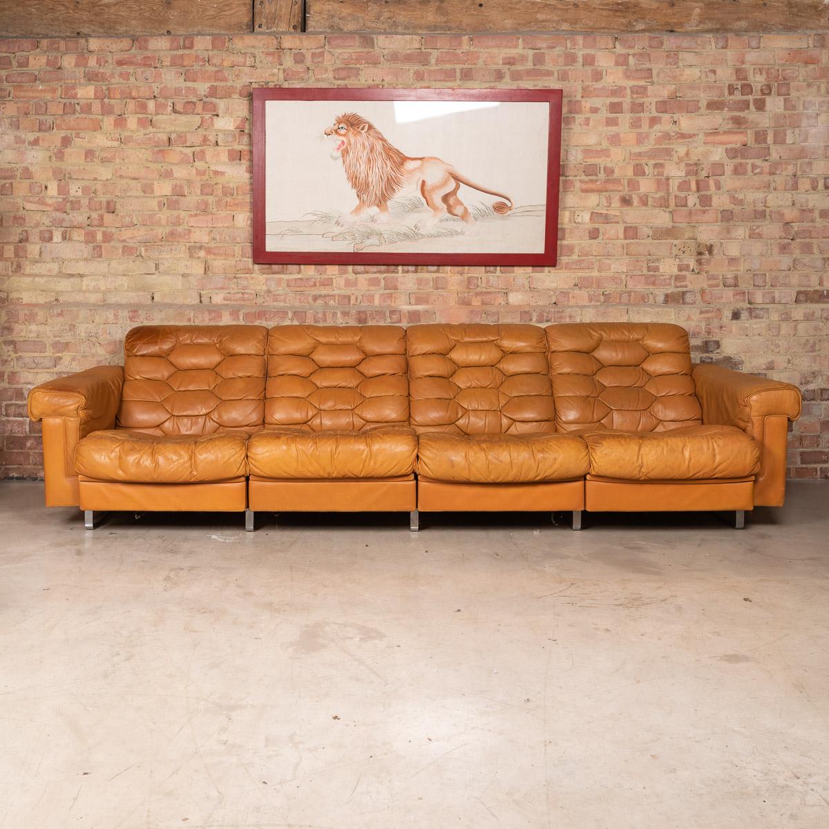 Stylish 20th century leather Italian very comfortable 4-seater sofa, each individual seat reclining, with polished chrome feet. A fashionable item of furniture capable of uplifting the interior space of any contemporary or traditional home, the