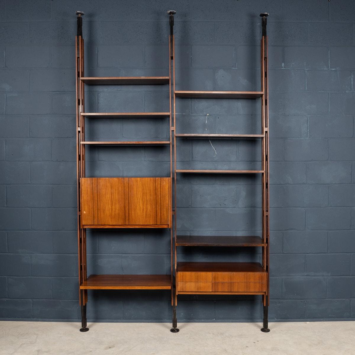 A mid-20th Century bookcase or room divider produced in the 1960s by Arform, designed by Paolo Tilche. Featuring wooden uprights, black painted wood end pieces, adjustable black terminals all of which can be arranged and assembled according to the