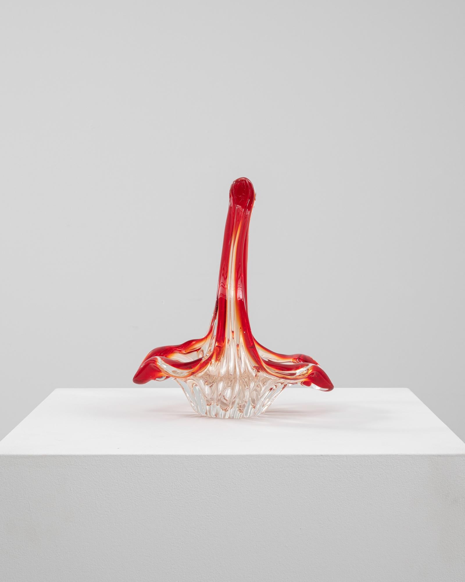 This 20th Century Italian glass plateau features a dramatic sculptural form, rendered in vibrant red and clear glass with rich ombré transitions. The handblown structure rises into an elegant loop, with fluid lines that twist and stretch upward in a