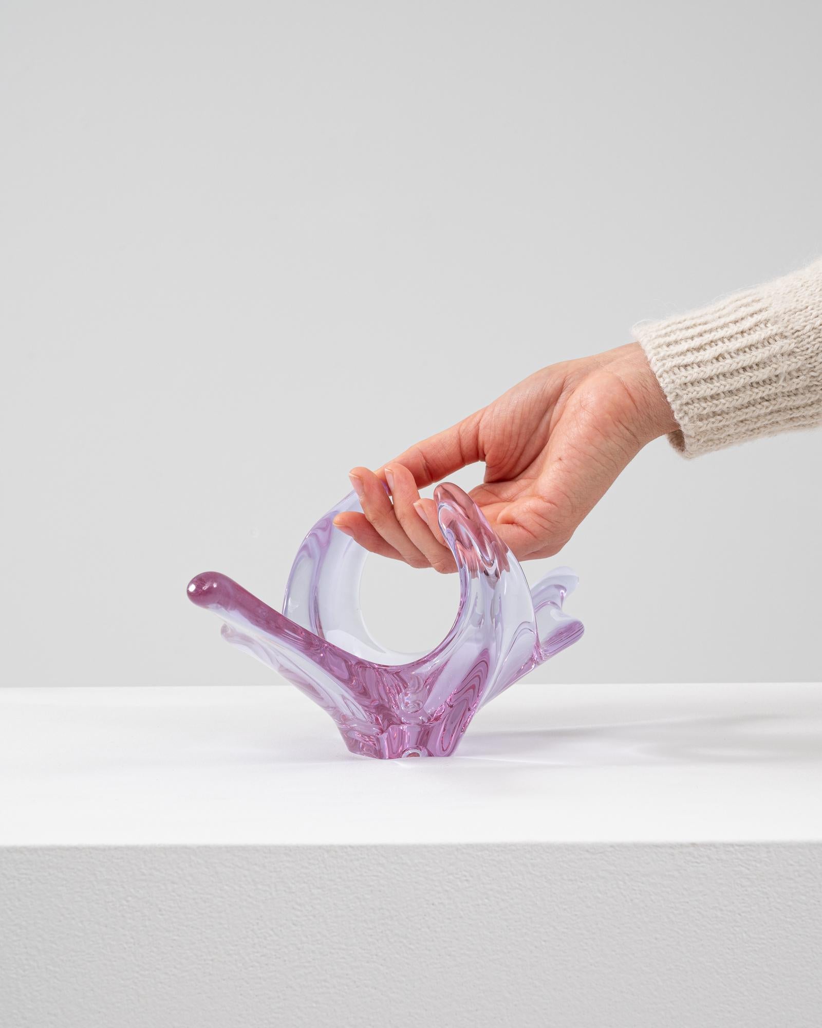 This 20th Century Italian glass plateau is a dynamic expression of Murano-inspired artistry, sculpted in a delicate lavender hue that transitions into soft rose tones. With sweeping, flame-like arms that curve upward and outward, the piece conveys