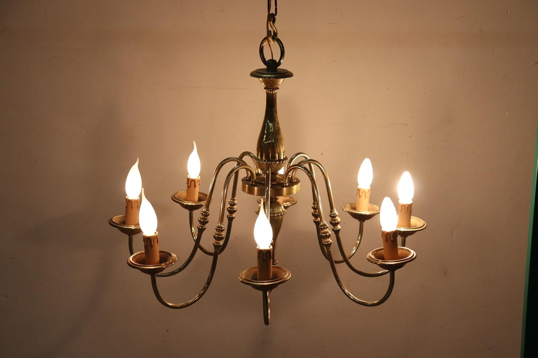 Beautiful and refined Italian chandelier 20th century, 1950s total eight lights. The chandelier is made with the Classic golden brass. Fully functional. The total height measurement shown can be changed by adding or removing links to the chain. The