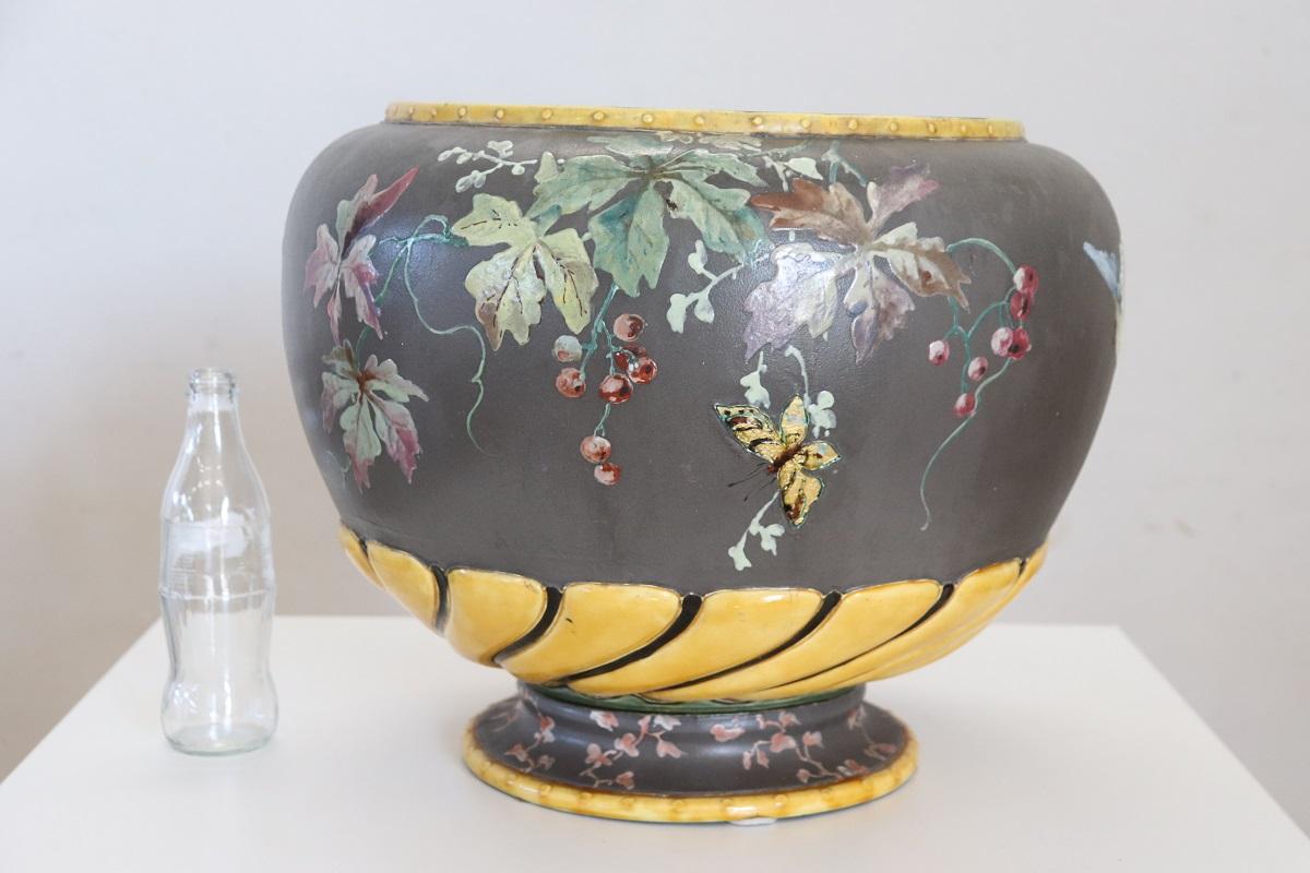 We present this stunning vase, made in Italy, dating back to the 1980s. The vase is crafted from polychrome ceramic. The eye-catching floral decoration adorning each side of this vase is sure to catch the eye. Large, colorful flowers and beautiful