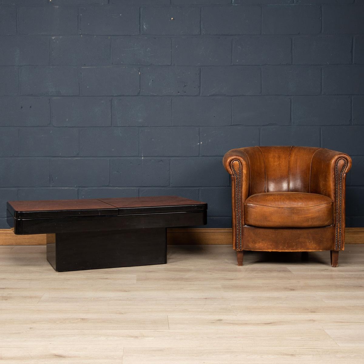 A stunning retro coffee table in the style of Aldo Tura, made in Italy around the 1970s. An exotic wood veneer finishes the table top and pops out wonderfully against the high gloss black ebonised base. The table opens up from a rectangle with ease