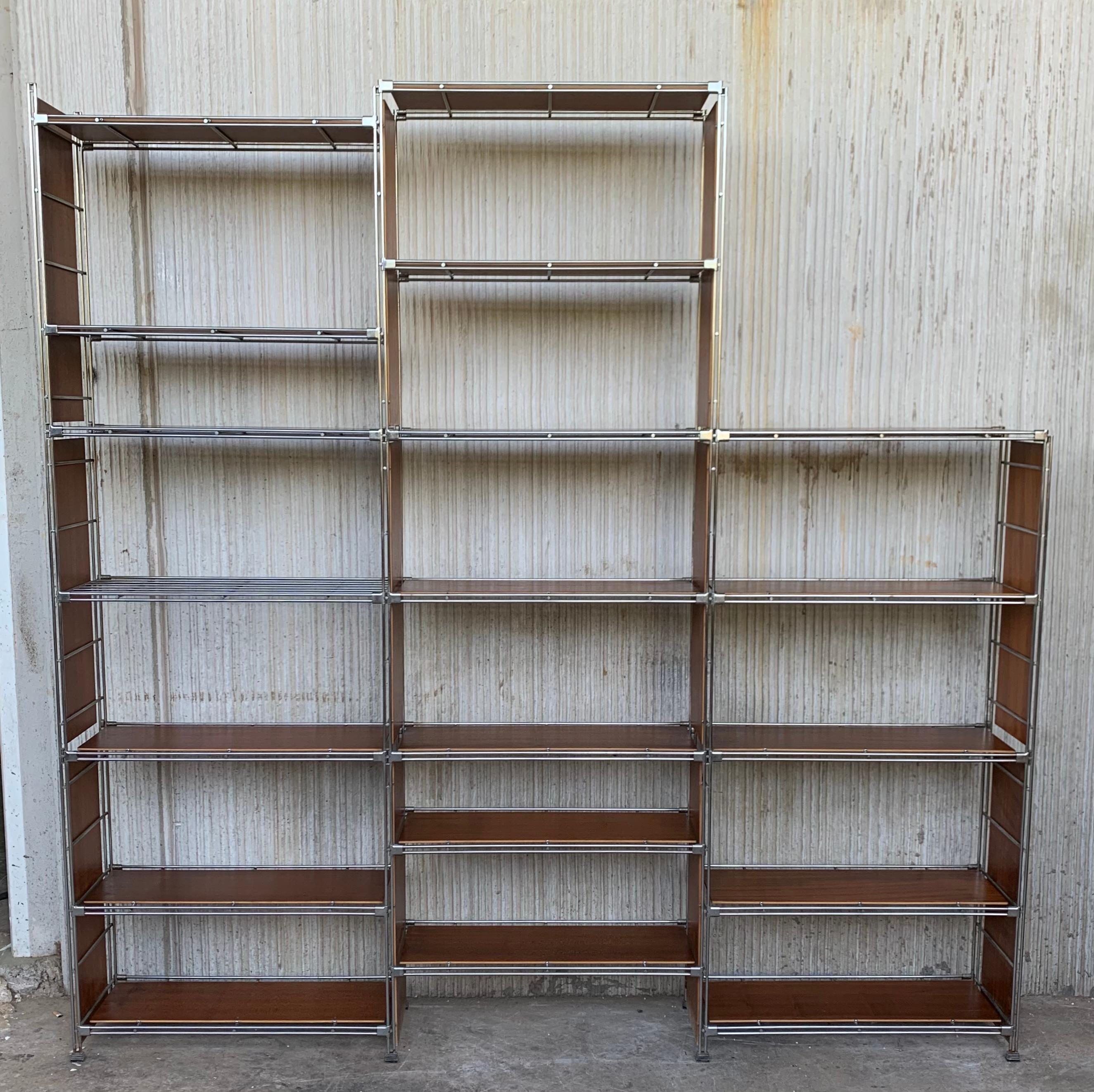 A French Industrial étagère with nickel mounted frame and shelves made of Eastern European oak. Very sturdy, heavy frame and decorative cast feet. 
The shelves are adjustable. In very good used condition with minor scratches. A versatile shelving