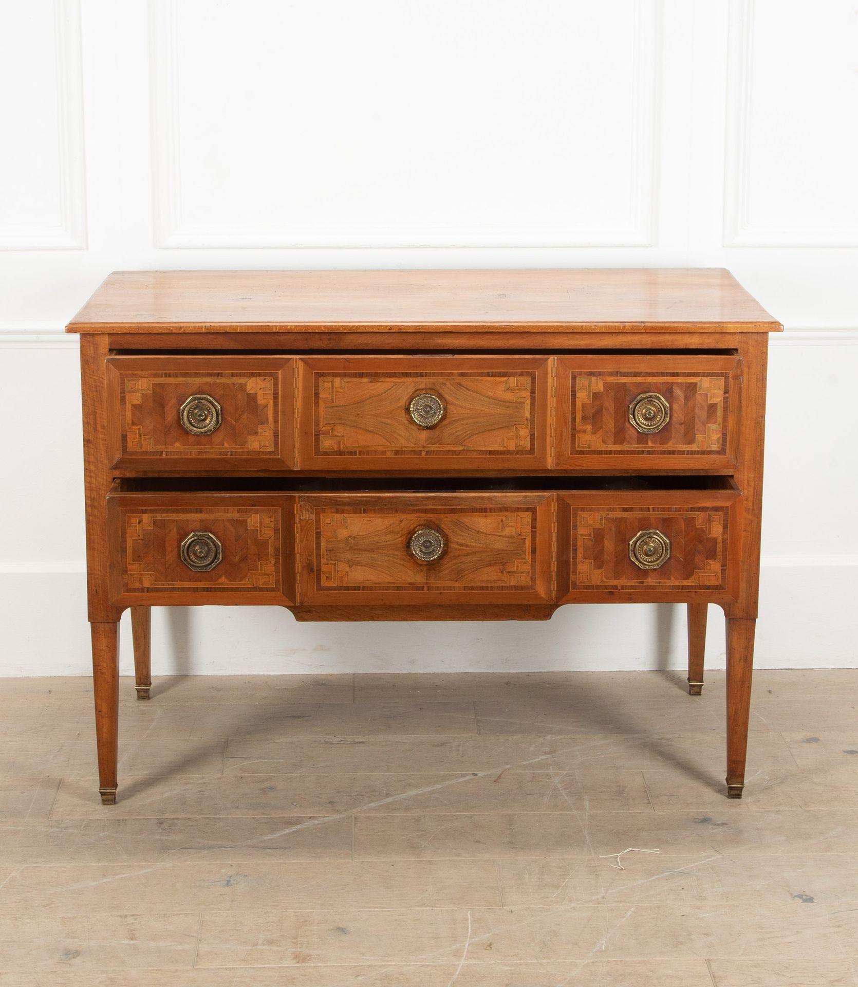 20th Century Italian two drawer walnut commode.
With decorative inlay, on tapering legs.
Circa 1900.