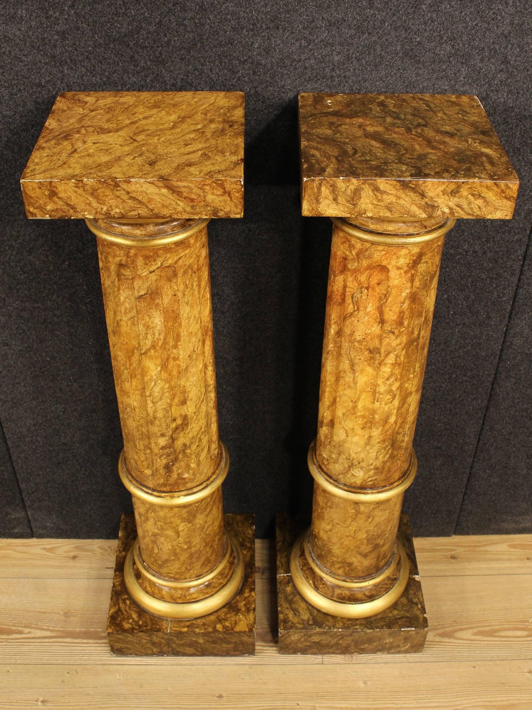 Pair of Italian columns of the early 20th century. Furniture made by ornately carved, gilded and lacquered faux marble wood of great taste and enjoyment. Columns of beautiful fit and proportion ideal to expose sculptures or objects, it can be easily