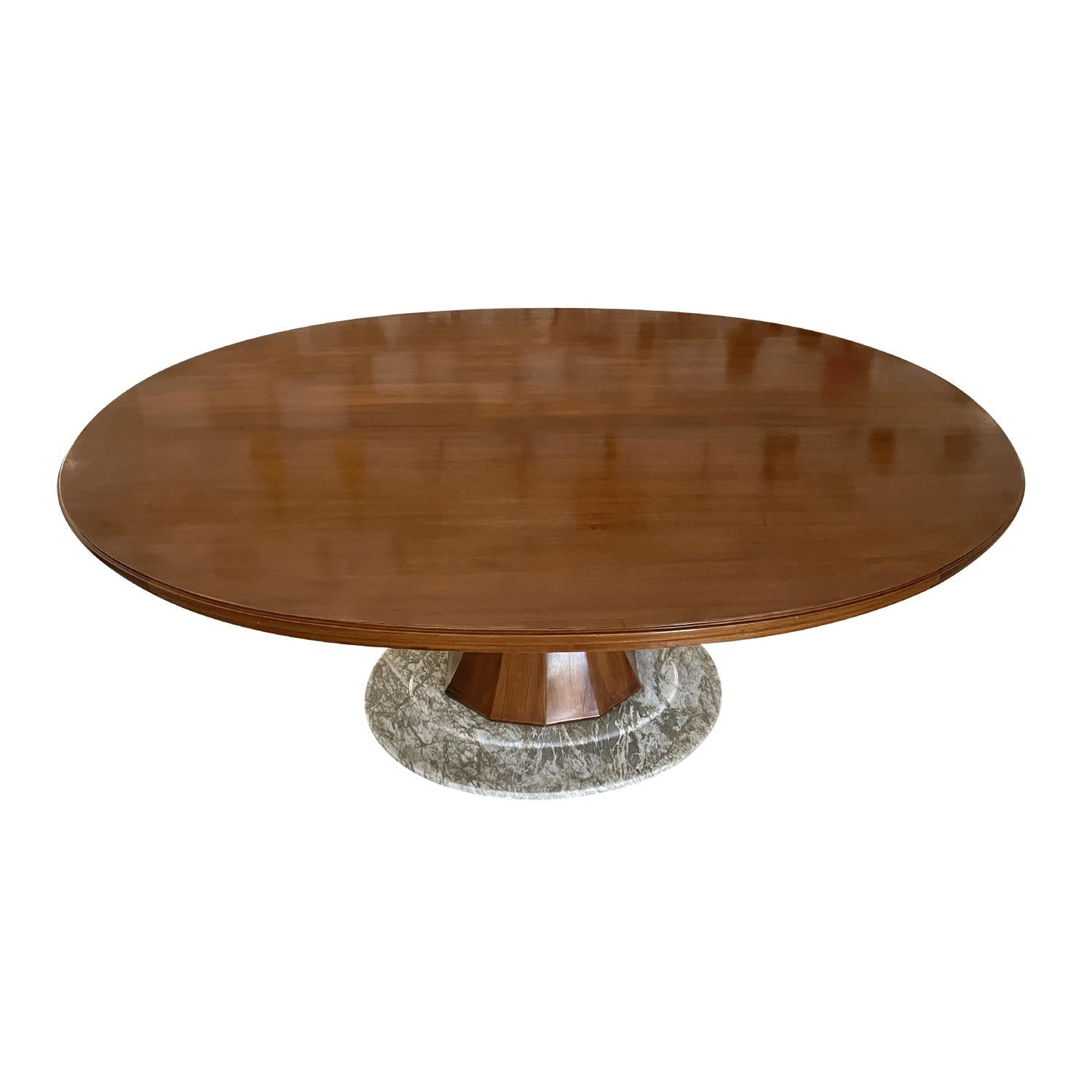 A dark-brown, large vintage Mid-Century Modern Italian oval dining table made of hand crafted polished Rosewood, designed by Vittorio Dassi in good condition. The thick table top is supported by a white-grey marble base, enhanced by detailed wood