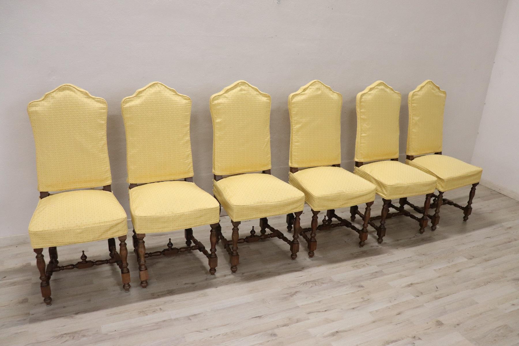 Series of six refined mid-20th century Italian Louis XIV style walnut wood chairs. The legs with turned decorations. Each chair has a protective yellow fabric that can be removed for washing. Perfect for a dining table. Beautiful chairs ready to be
