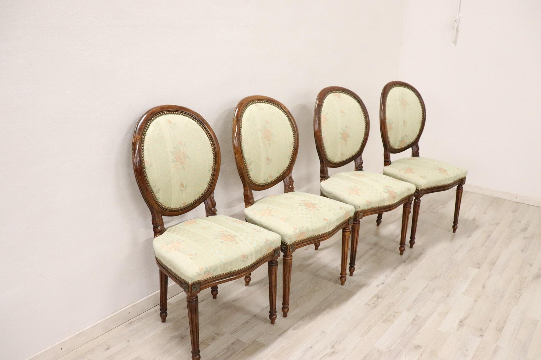 Series of four refined 20th century Italian Louis XVI style beechwood four chairs. Refined decoration with golden bronze border. The seat is wide and comfortable. Perfect venue for an important dining table. The chairs are used have small signs of