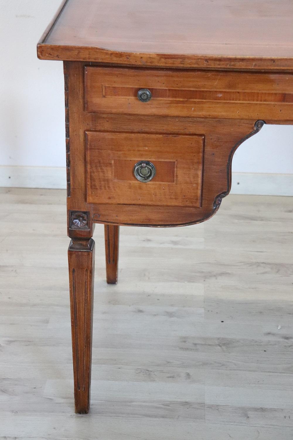 Elegant Italian Louis XVI style writing desk. Rare and precious solid walnut wood. Comfortable size for a practical use. The desk has elegant straight legs. Equipped with four practical drawers. The wooden decoration is on each side so it is