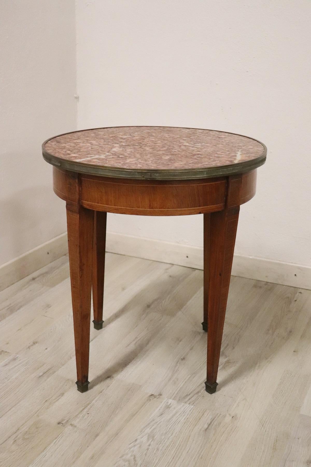 Rare and fine quality Italian Louis XVI style, 1930s side table or coffee table. The table has a particular legs slender. Fine inlay walnut decoration in precious wood. Red Italian marble top. Precious gilt bronze decorations with ancient patina.