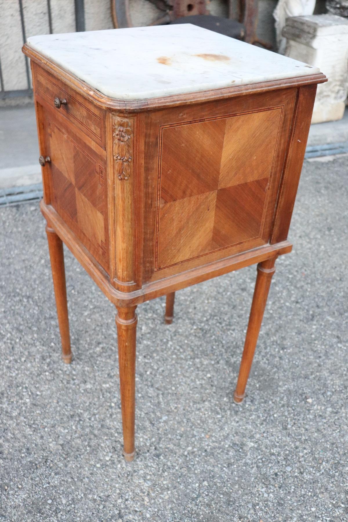 Rare and fine quality Italian Louis XVI style, 1930s side table or nightstand table. The table has a particular legs slender. Fine inlay marquetry decoration in precious rosewood. On the front one comfortable little drawer. White marble top. The