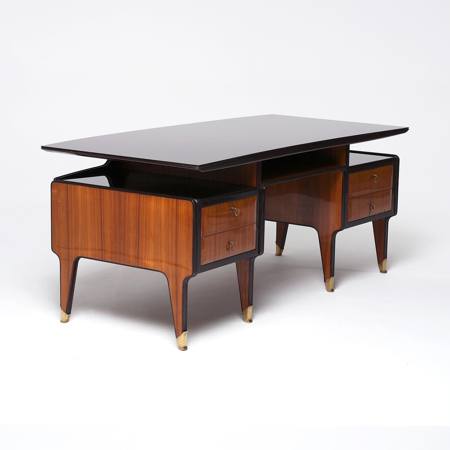 A freestanding, half rounded vintage Mid-Century modern Italian writing table made of hand crafted shellac polished, party veneered Mahogany and Rosewood, designed by Vittorio Dassi in good condition. The floating top is composed with its original