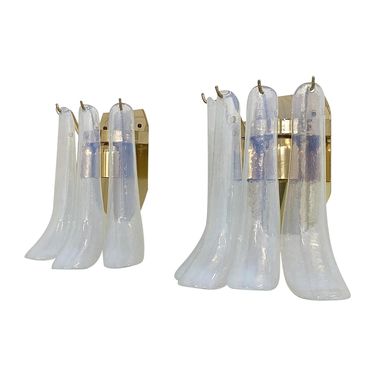 A vintage Mid-Century modern pair of Italian wall sconces made of hand blown colored Murano glass, designed and produced by La Murrina in good condition. Each of detailed appliques are composed with four sculptural glass rays which are in the shape