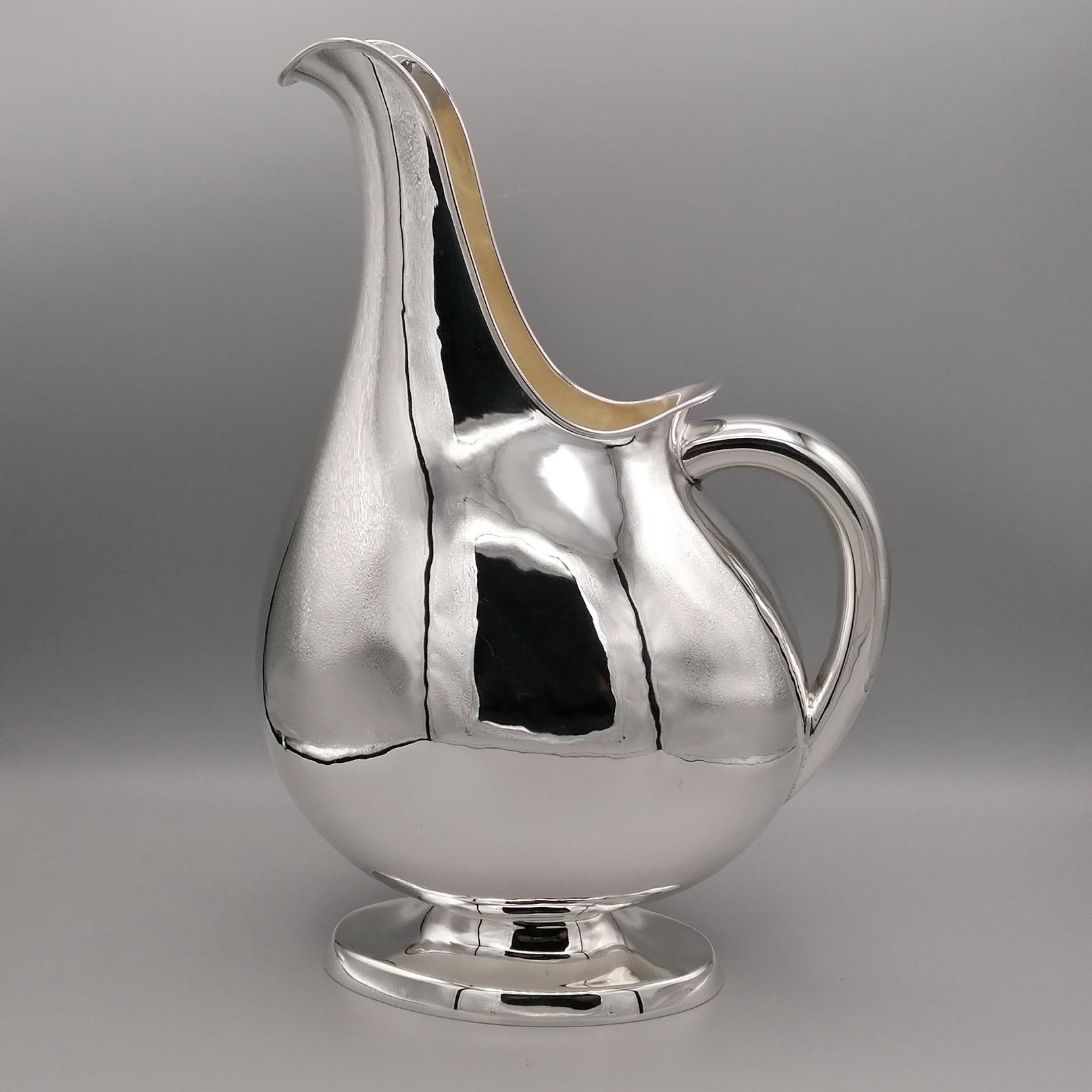 Modern style solid silver pitcher.
The shape of the jug is oval and has been completely handmade from an 800 silver plate.
The body of the object is lightly hammered.
The handle is oval and completely smooth.
The elongated upward shape makes it