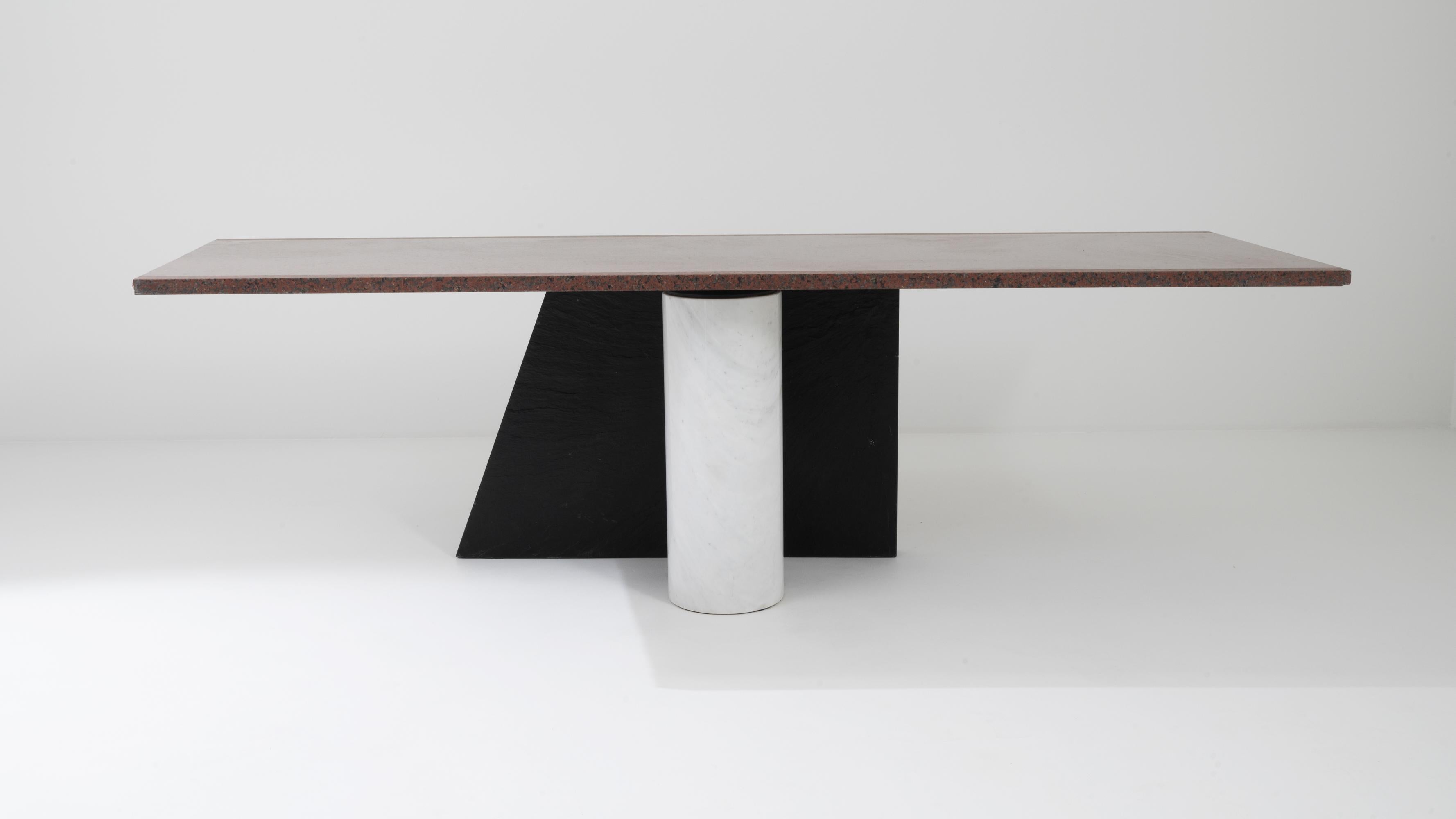 Abstract and experimental, this vintage marble table offers a compelling slice of design history. Made in Italy in the 20th century, the form reflects the bold geometric tendencies of the avant garde Bel Design movement. The table is composed of