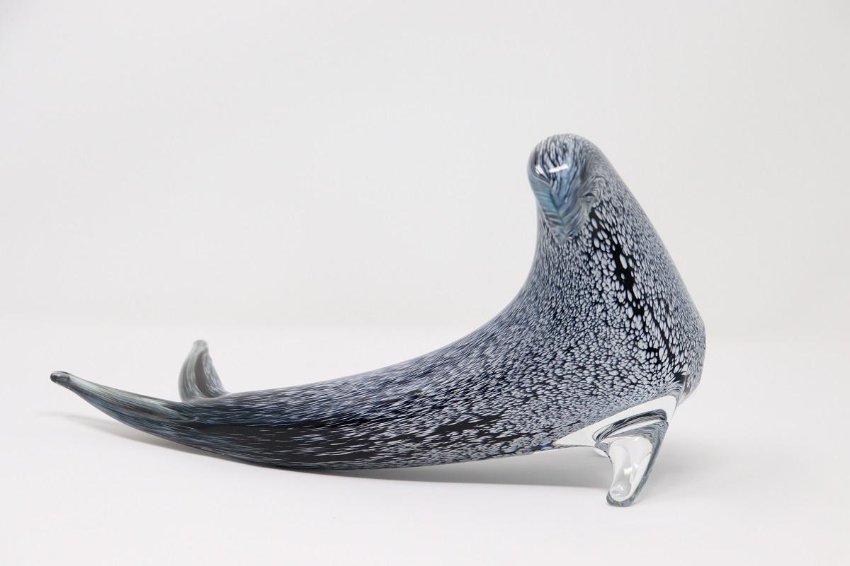 This Murano glass sculpture of a seal is like a remarkable piece that showcases the expertise and artistry inherent in Murano glassmaking. The use of the blown glass technique in thick black glass, accentuated with small spots for a gray spotted