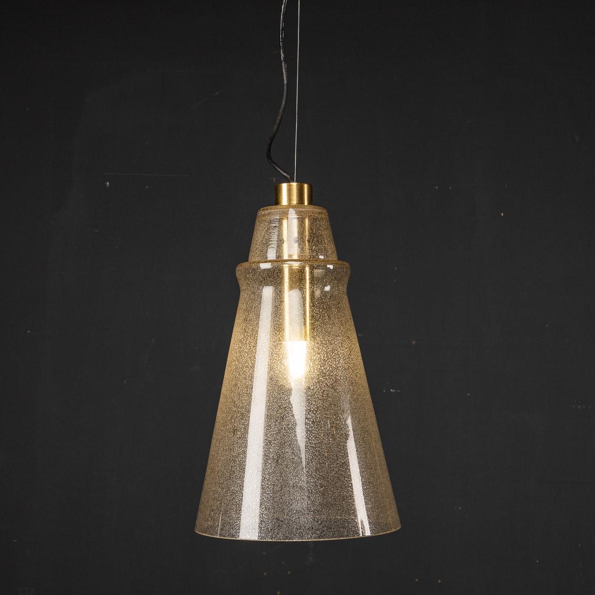 Mid 20th Century Italian Murano glass cone shaped shade pendant light with brass fittings. This light was created in the iconic 1970’s.

CONDITION
In Great Condition - wear consistent with age.

SIZE
Height: 46cm
Diameter: 27cm.