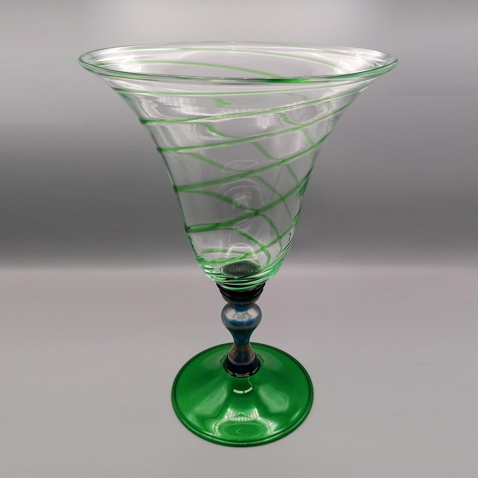 20th century Italian murano glass vase

Glass vase made in Murano - Venice - Italy by the Gabbiani artisan factory.
The base is green, while the stem is blue where flakes of pure gold have been inserted.
The cup is flared and made of clear