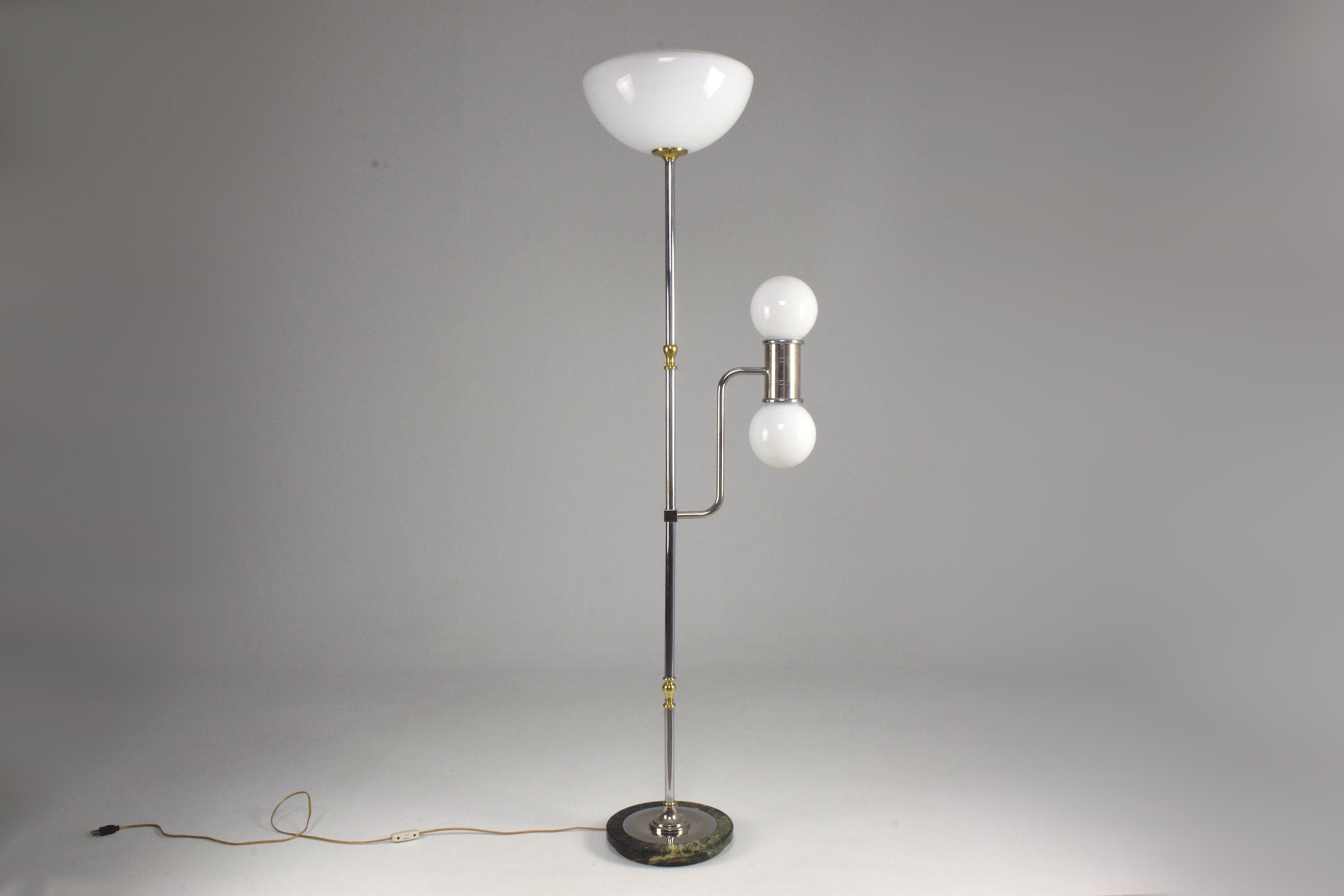 A stunning midcentury vintage floor lamp designed in chromed steel with two opaque Murano glass shades and a Guatemalan green circular base. The silver stem has polished brass details.
Labeled Vetri Murano.
Italy, circa 1950s.
----

All our pieces