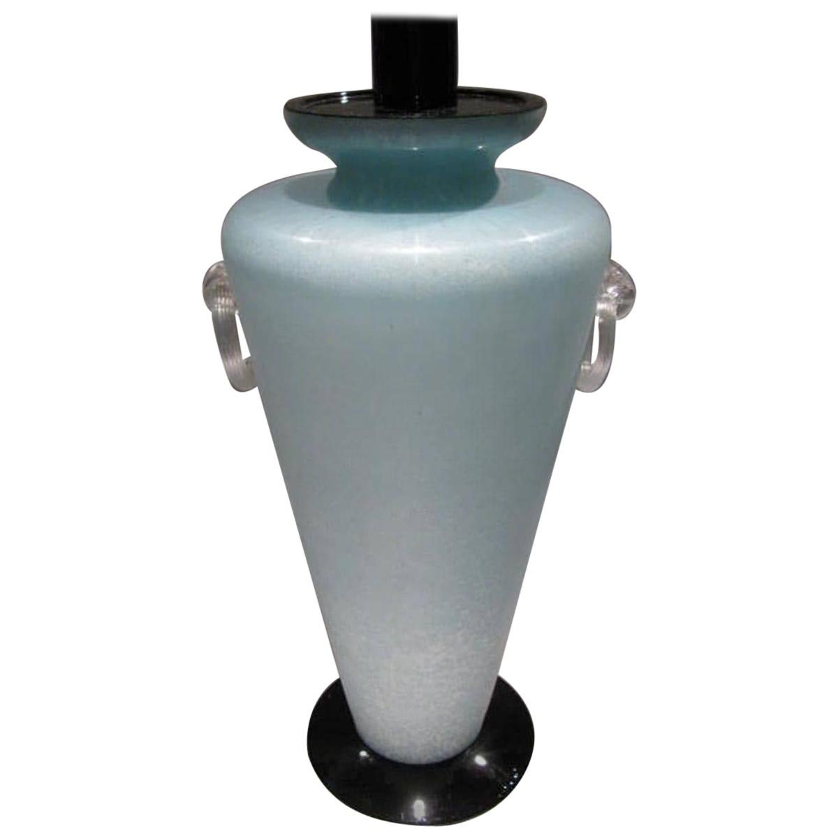 A Scavo technique aquamarine-green color glass vase mounted as circular table lamp, made in Murano, near Venice, Italy, circa 1980s.
The Scavo finished glass, hand blown in a beautiful aquamarine green tone and black details, offers an elegant