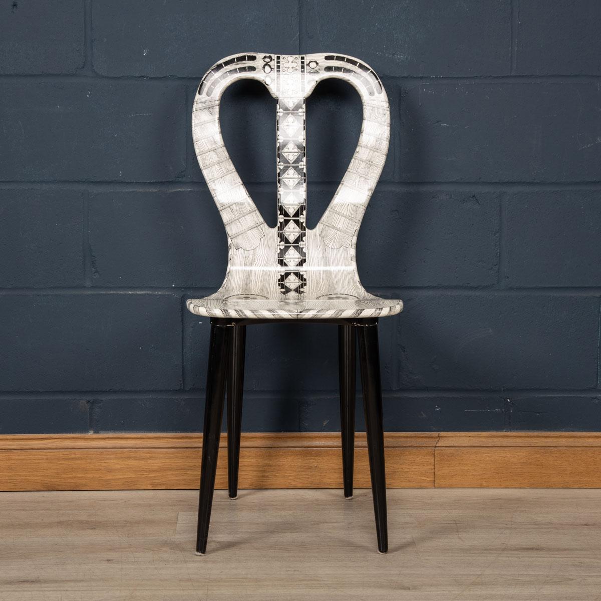 A very rare chair by Fornasetti Studios made in Italy towards the latter end of the 20th century. These chairs are handcrafted using the original artisan techniques. It is silk-screened by hand, hand painted and covered with a smooth lacquer. This