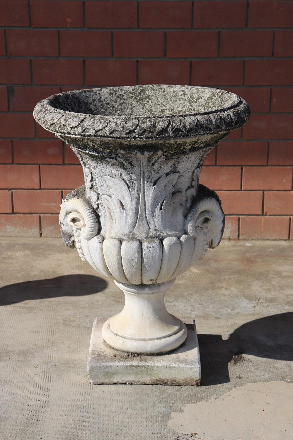 Beautiful refined garden vase in neoclassical style, circa 1930s made of carved limestone. Beautiful and majestic. The vase has a refined classic decoration with acanthus leaves and two large ram heads. The stone shows signs of the passage of time.