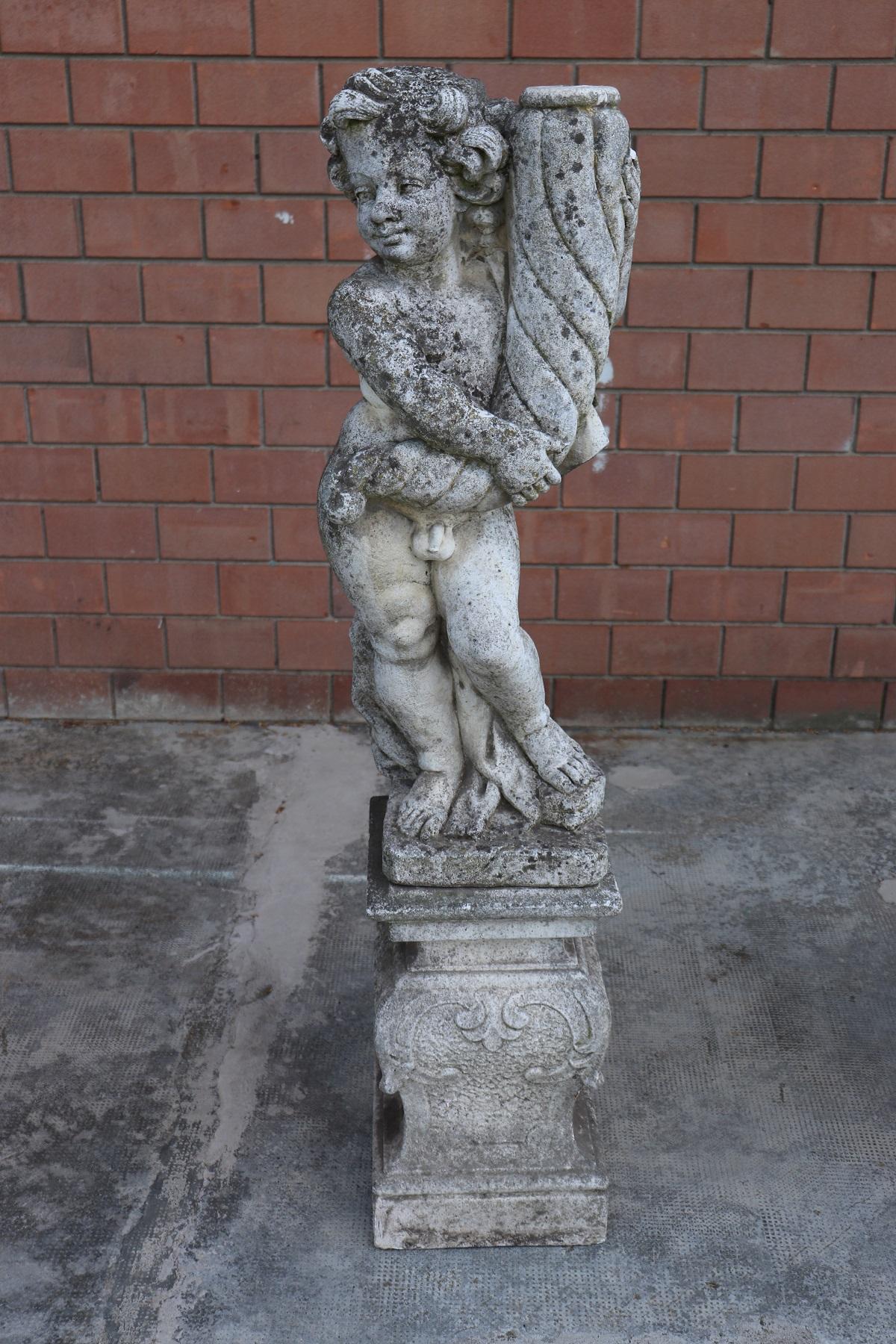 Large pair of garden lighting with statues with a base made of cement, 1920s. Two cherubs holding a horn of plenty. The interior of the statues and of the base are perforated and allow the passage of lighting wires. These two statues will be perfect