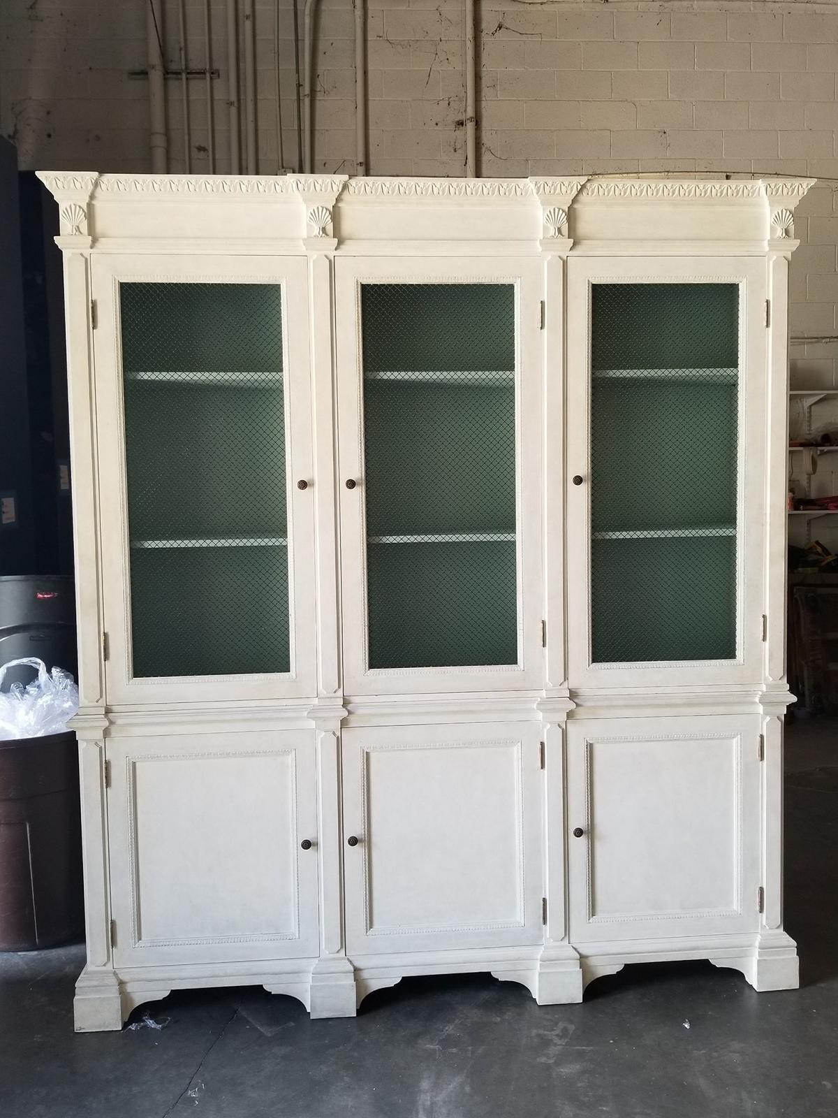 20th century Italian neoclassical Regency custom painted breakfront with chicken wire and shell motif
Two pieces
Widest and deepest parts at crown (at the top)
Measures: Overall: 81.75