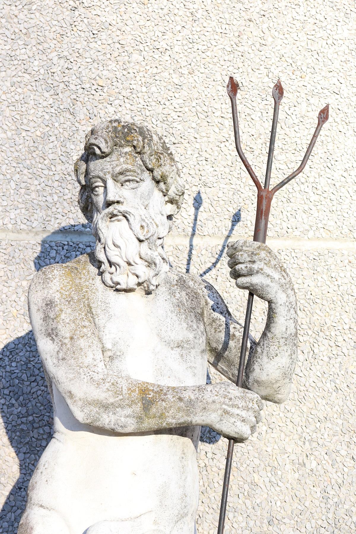 Beautiful refined garden fountain with statue in neoclassical style, circa 1930s main material stone mixed with gravel and cement. Beautiful and majestic statue of Neptune with spear in handmade of stone. The stone shows signs of the passage of